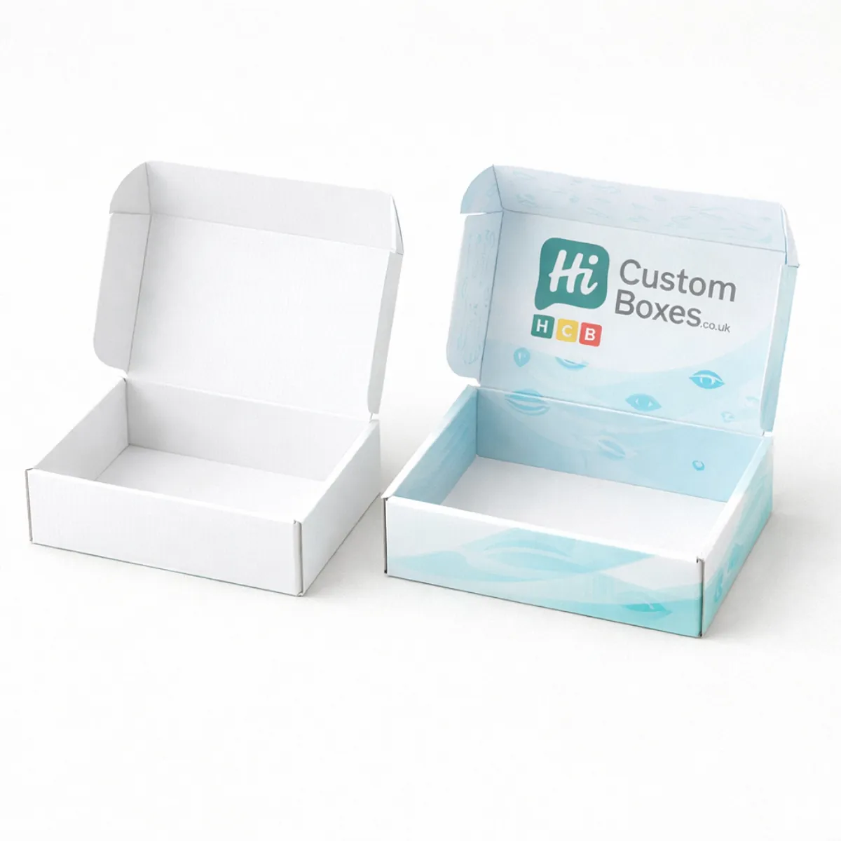 Two open mailer-style boxes- one plain white and one printed with light blue graphics and a logo- class=